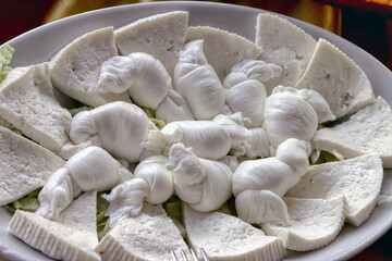 Tray of knots, a type of Apulian mozzarella and primo sale cheese. Dairy products, cheeses
