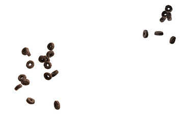 Chocolate rings cereal spill out into a bowl. Breakfast.