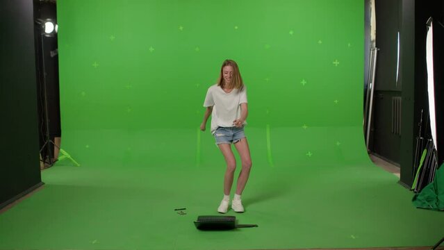 Angry worker breaking laptop. Young woman throwing the computer on Green screen background, chroma key.