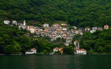 Fototapeta na wymiar Famous and beautiful small towns on Lake Como in Italy. Beautiful small towns with old streets, villas, beautiful gardens and nice restaurants. Lombardy region