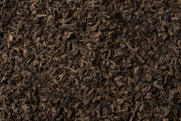 Dried tea leaves as a background.