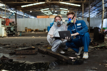 Fototapeta na wymiar Team inspector chemical and hazmat wearing protective mask using laptop and write note on clipboard. Wastewater chemical residue in factory. Analysing harmful substances to human body environment.