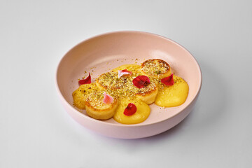 Cheesecakes with coconut-mango espuma. Ukrainian syrnyky