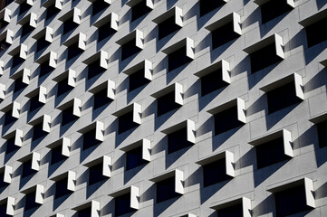 Horizontal color image of a facade of a modern multi-storey residential building wall with...