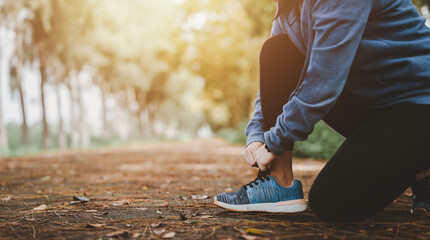 Health and lifestyle concepts, Fitness, Exercising, jogging, running. Asian woman tying her shoes...