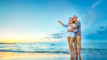 Plan life insurance of happy retirement concepts. Portrait of Senior couple embrace on the beach...