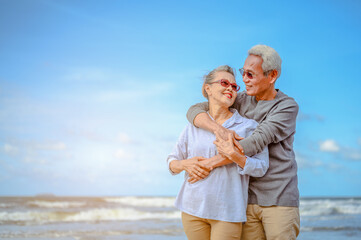 Plan life insurance of happy retirement concepts. Portrait of Senior couple embrace on the beach...