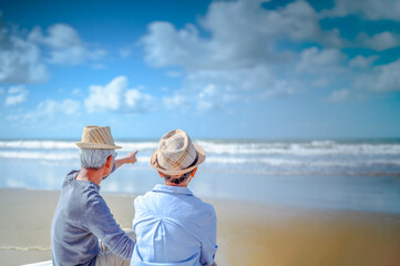 Plan life insurance of happy retirement concepts. Senior couple sitting on chairs at the beach...