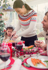 Woman cutting turkey at Christmas table