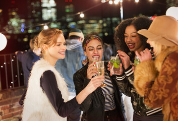 Young women drinking and enjoying rooftop party