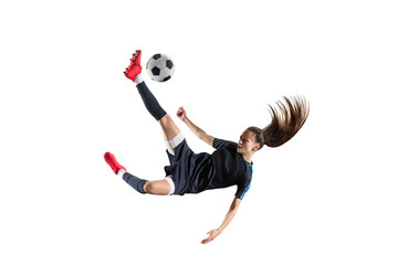 Competitive spirit. Young professional football player in motion, kicking ball in jump isolated on...