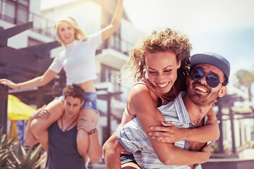 Playful couples piggybacking