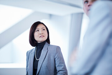 Businesswoman listening to businessman