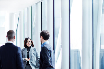 Business people talking at office window