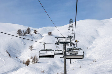 Ski lift and empty ski piste in winter skiing resort