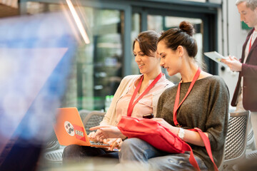 Female college students using laptop