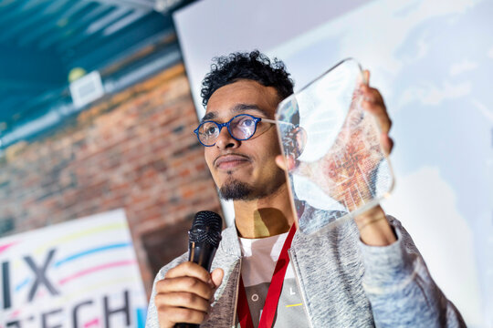 Speaker presenting prototype at technology conference