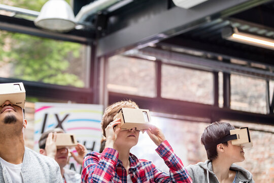 Audience trying virtual reality simulator glasses at technology conference