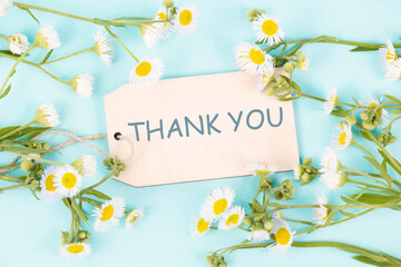 Thank you  card surrounded by flowers, being thankful, support, help and charity concept, positive...