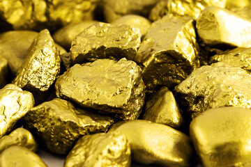 gold nuggets on white background isolated. High resolution photo of gold stones. Concept of luxury and wealth.