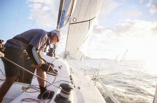Retired man sailing on sunny ocean