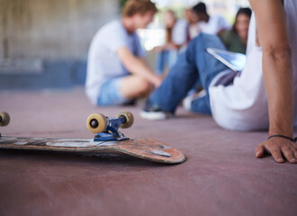 Skateboard upside-down next to teenage friends hanging out at skate park © KOTO
