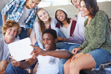 Teenage friends hanging out taking selfie with digital tablet