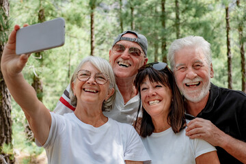 Group of Senior Friends Enjoying Trekking Day on Forest - Elderly Caucasian Men and Women Take...