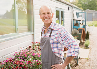 Portrait smiling plant nursery small business owner