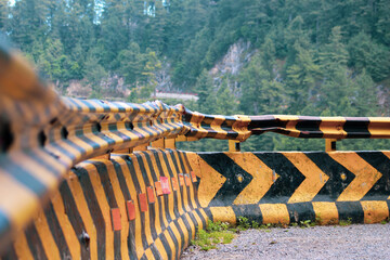 Road turn arrow in mountain side