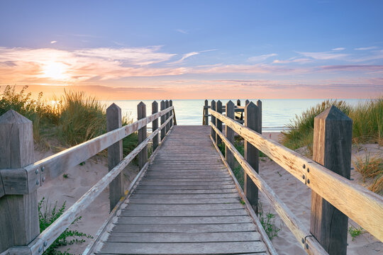 Stairs entrance over high dunes with a view of the North Sea coast