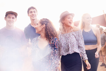 Young friends walking at music festival