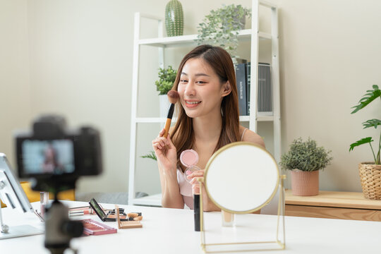 Social media influencer beauty blogger concept, Young beautiful woman recording video review cosmetic and makeup tutorial.
