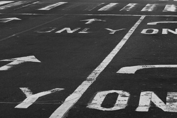 Closeup of traffic signs on asphalt in New York City, USA