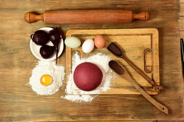 Purple dough bun for noodles with ingredients on the table.