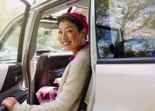 Portrait Smiling Woman Getting Out Of Car