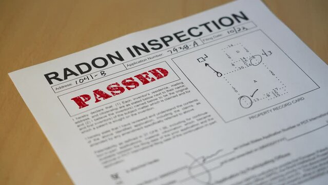 A closeup view of a radon home inspection is stamped PASSED. Data on form is fictional.  	