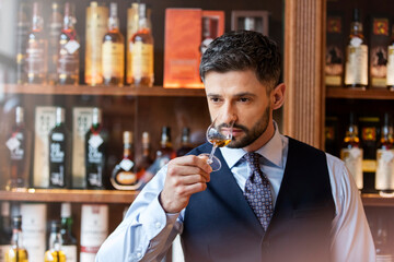 Well-dressed man whiskey tasting