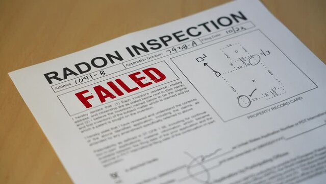 A closeup view of a radon home inspection is stamped FAILED. Data on form is fictional.  	