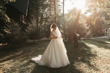 Beautiful bride in wedding dress outdoors in a forest.
