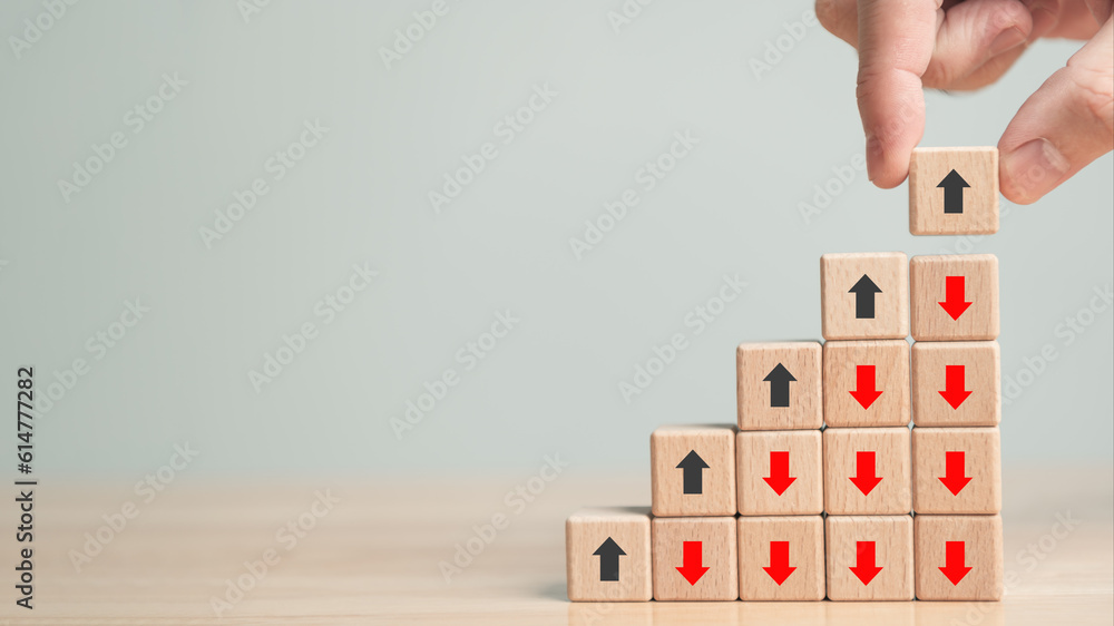 Poster rising and falling arrow trend. up and down point arrow on wooden cube block for stock economic and 