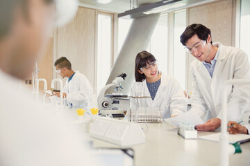 College students conducting scientific experiment in science laboratory classroom