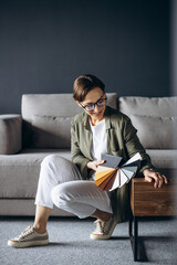 Woman designer holding swatch in furniture store