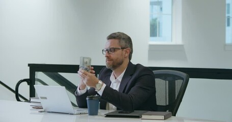 Earn money. Business man counting dollars in office. Business man in suit with money dollars. Businessman hold dollars money banknotes. Business man in suit count dollars. Business man give money.