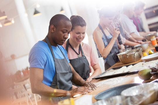 Couple enjoying cooking class in kitchen