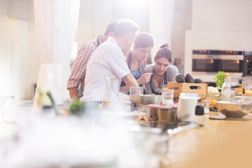 Teacher and students in cooking class kitchen