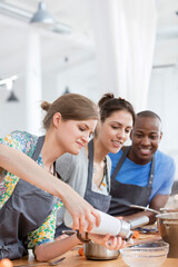 Friends enjoying cooking class in kitchen