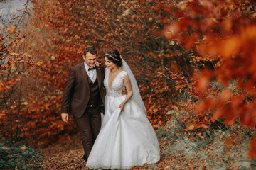 Wedding couple on a walk in the autumn park, medium portrait, place for text