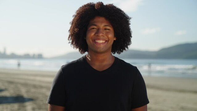 Close Up Portrait Of Attractive Black Woman Smiling At The Beach On A Sunny Day
