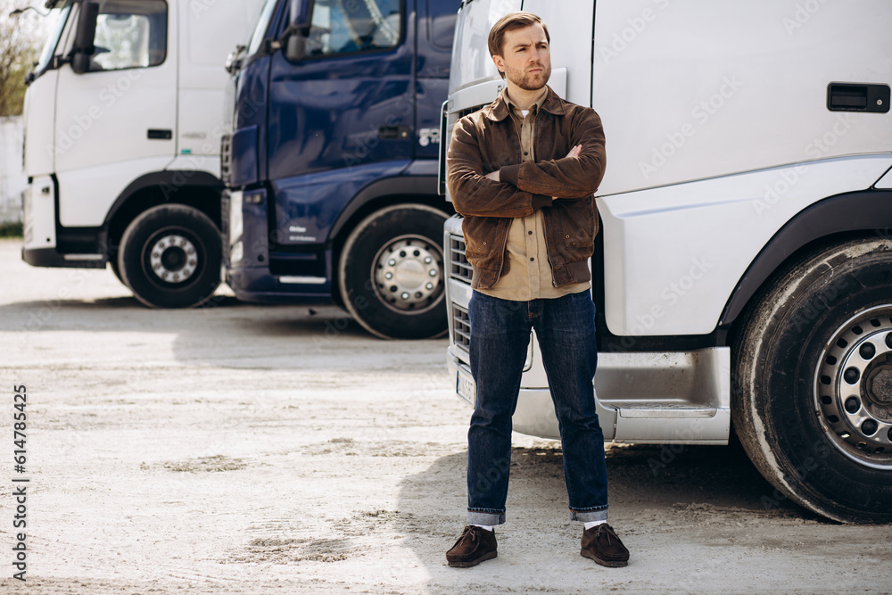 Wall mural Truck driver standing by his lorry